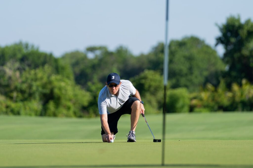 man surveying putt