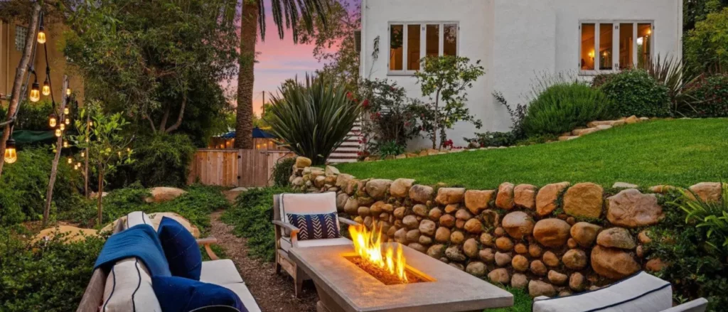 lounge chairs and sofa around fire pit at sunset